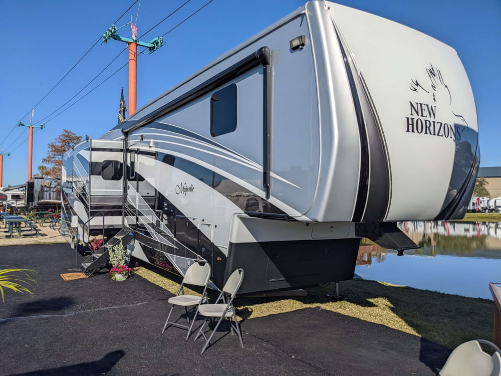 An impressive lineup of the biggest 5th wheel campers parked side by side, showcasing their luxurious exteriors and spacious designs, ready for travelers who prioritize comfort and style on the road.